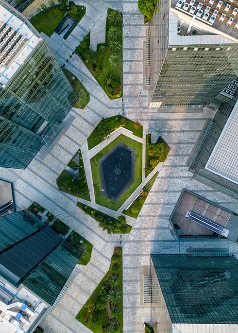 A fountain in the middle of a modern building from a drone view