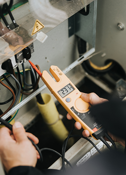 Electrician measuring electrical voltage